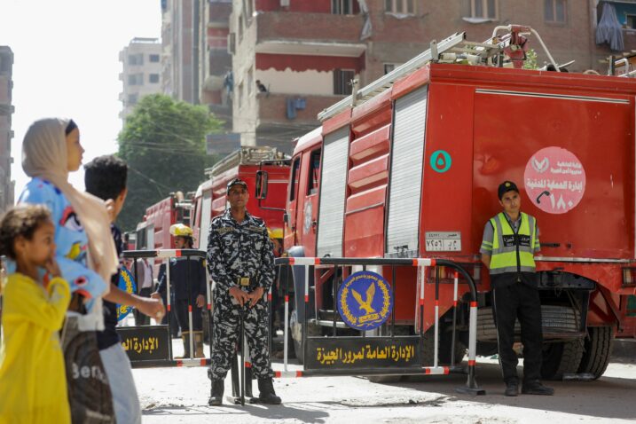 People and police gather near the scene where a deadly fire broke out at the Abu Sifin church in Giza, Egypt, August 14, 2022. REUTERS/Mohamed Abd El Ghany