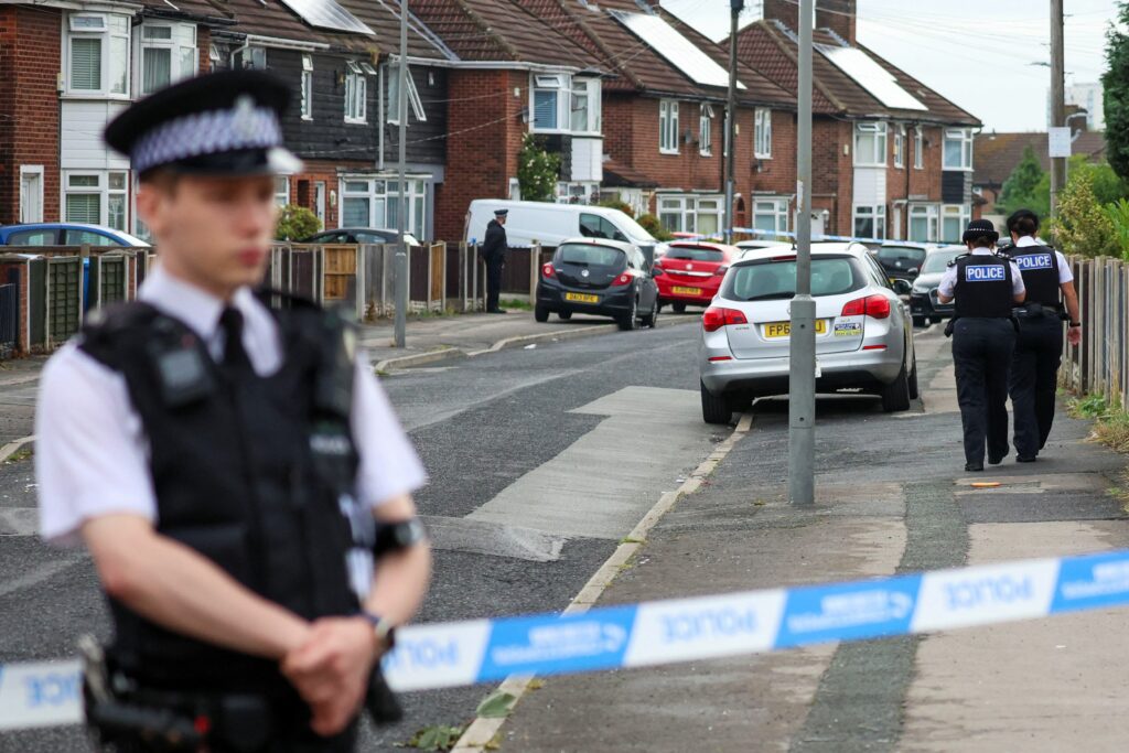 A police officer stands outside the house where a 9-years-old child was shot overnight in Liverpool, Britain August 23, 2022. REUTERS/Phil Noble