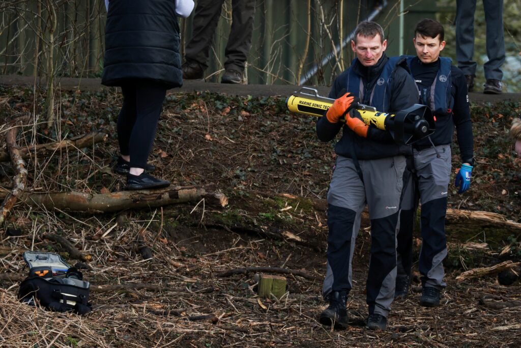 A member of the Specialist Group International carries a side scan sonar as they continue to search River Wyre for Nicola Bulley who is currently missing in Lancashire, Britain February 6, 2023. REUTERS/Phil Noble